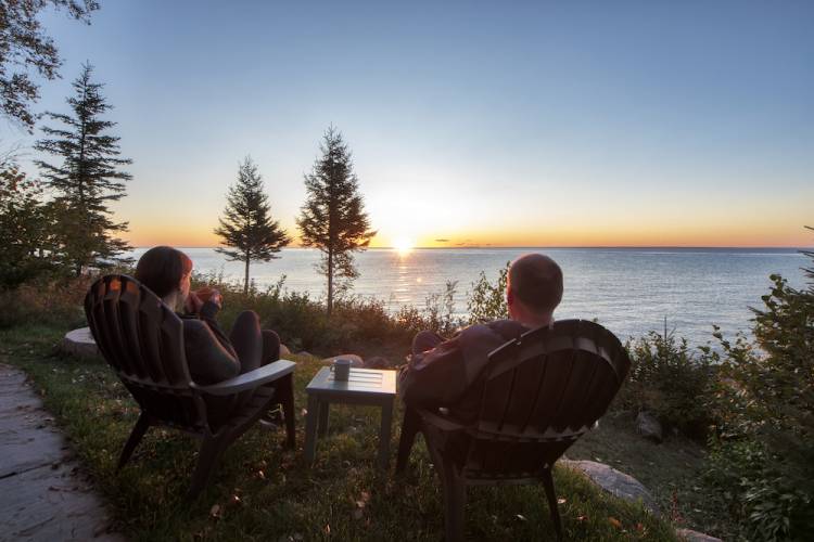 couple on vacation sitting on porch overlooking water