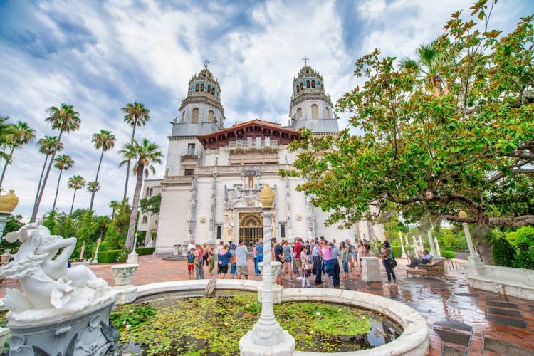 front view of Hearst Castle with tour groups outside 